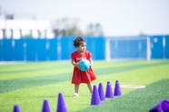 足球场上抱球玩耍的小女孩图片