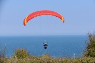 红色滑翔伞降落图片