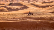 男子沙漠中驾驶摩托四轮车图片